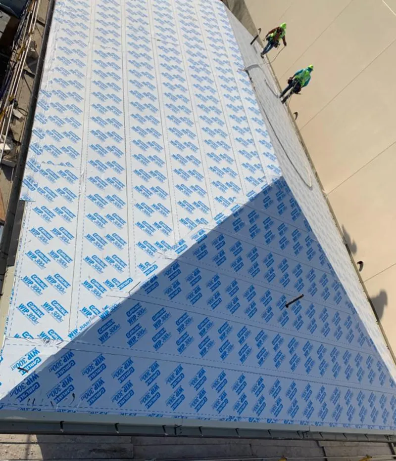 Professional roofers installing underlayment on a metal roof in Litchfield Park